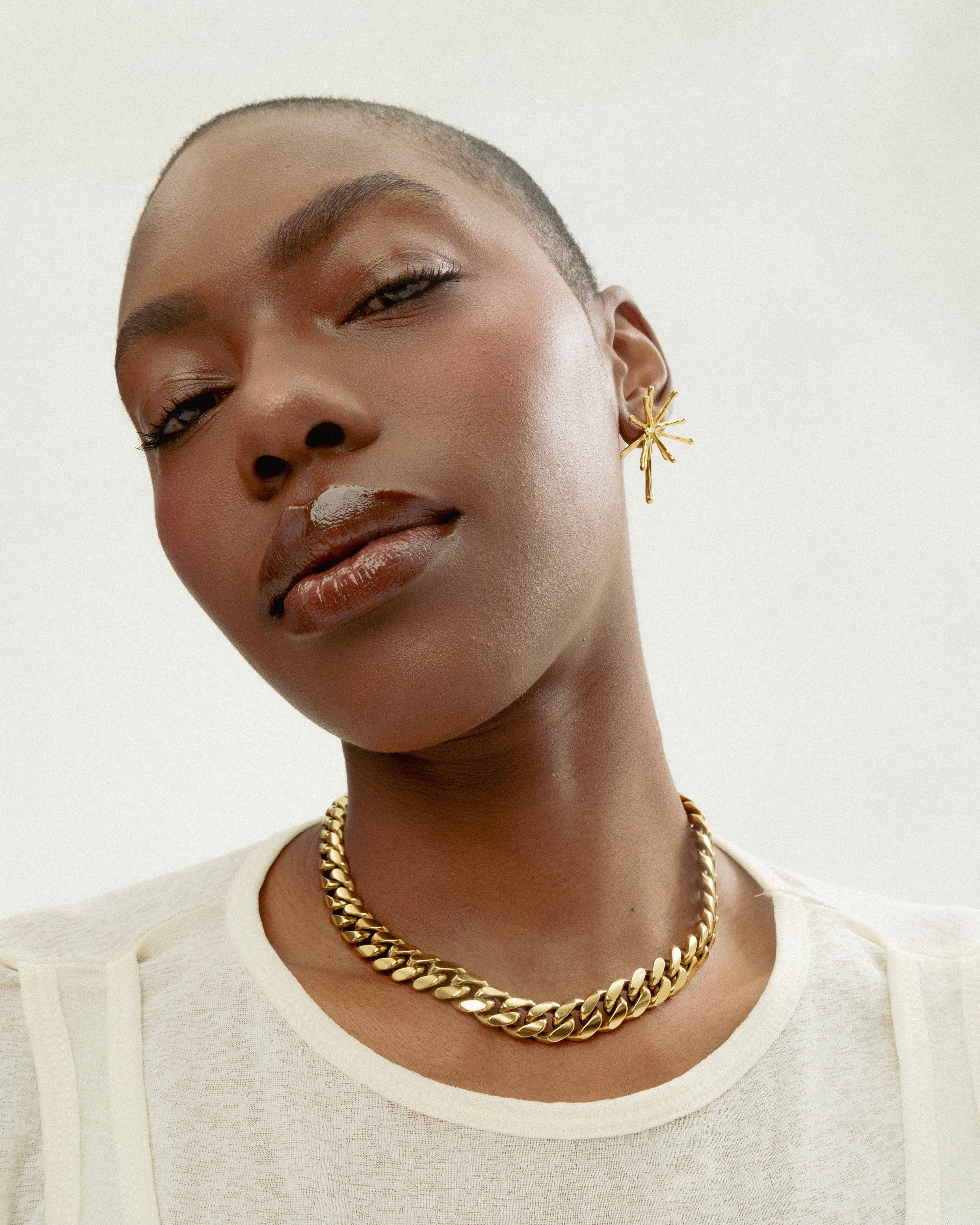 Model close up of 18k gold thick cuban link necklace by GRISÉ NYC