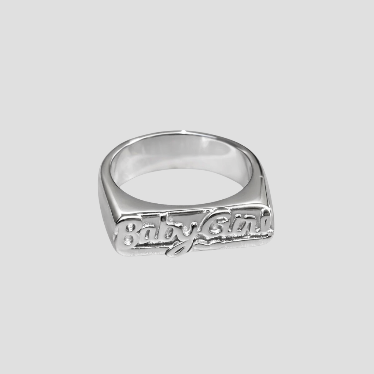 Babygirl Stainless Steel Ring by GRISÉ NYC featuring raised script lettering in polished stainless steel on a light grey background