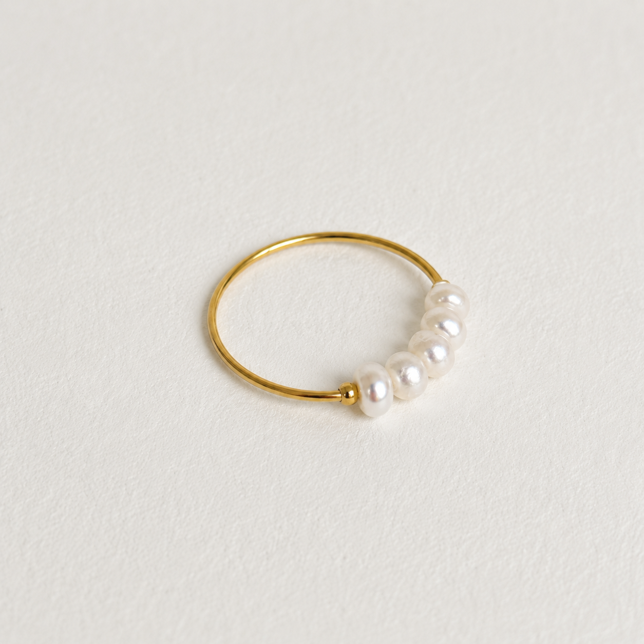 Dainty Freshwater Pearl Ring in 18k gold plated stainless steel with genuine freshwater pearls displayed on a clean white background by GRISÉ NYC.
