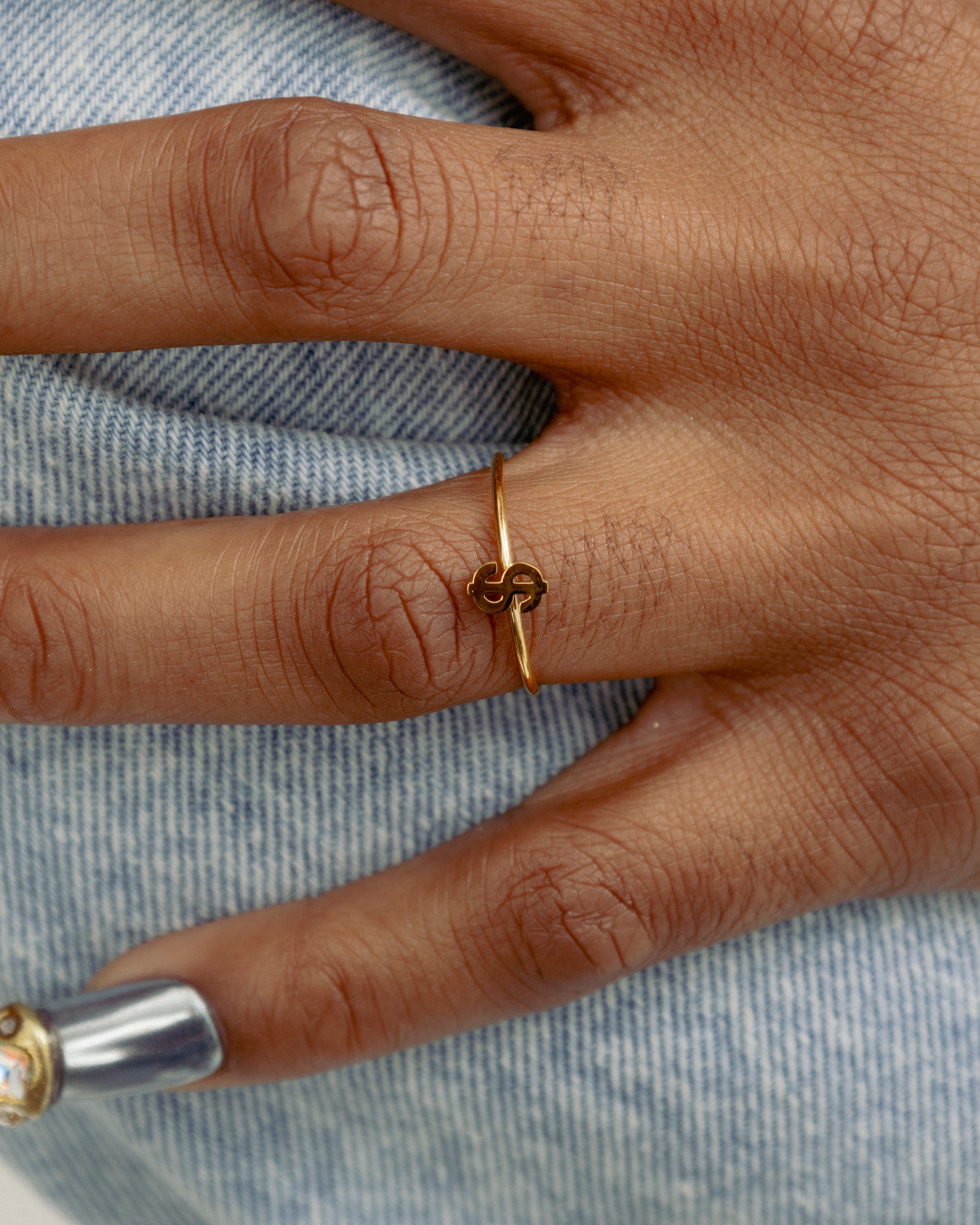 Close up of Dainty Money Dollar Ring by GRISÉ NYC worn on hand showcasing minimal gold stacking ring styling