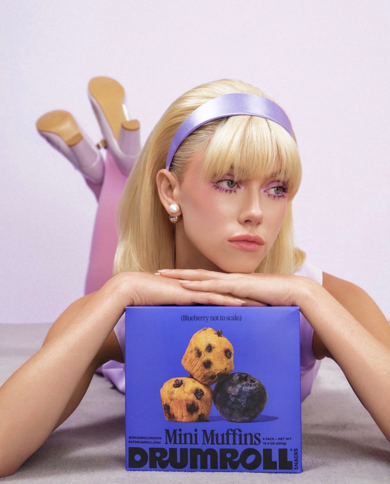 Drumroll ad featuring GRISÉ NYC 2 in 1 pearl and stainless steel stud earrings.