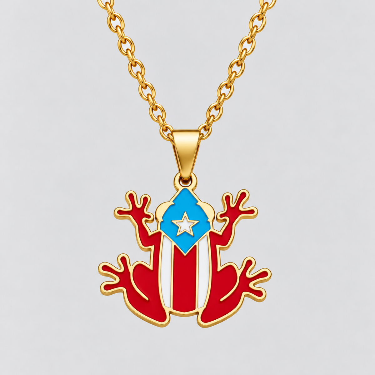Gold Puerto Rican Coquí Frog Necklace by GRISÉ NYC featuring red, white, and blue enamel flag detailing on a gold chain.
