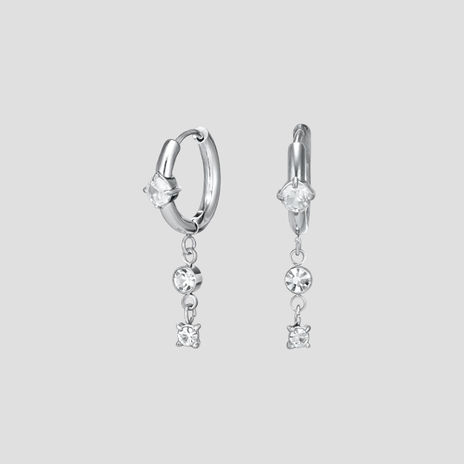 GRISÉ NYC silver dangle gemstone hoop earrings in stainless steel with cubic zirconia stones.