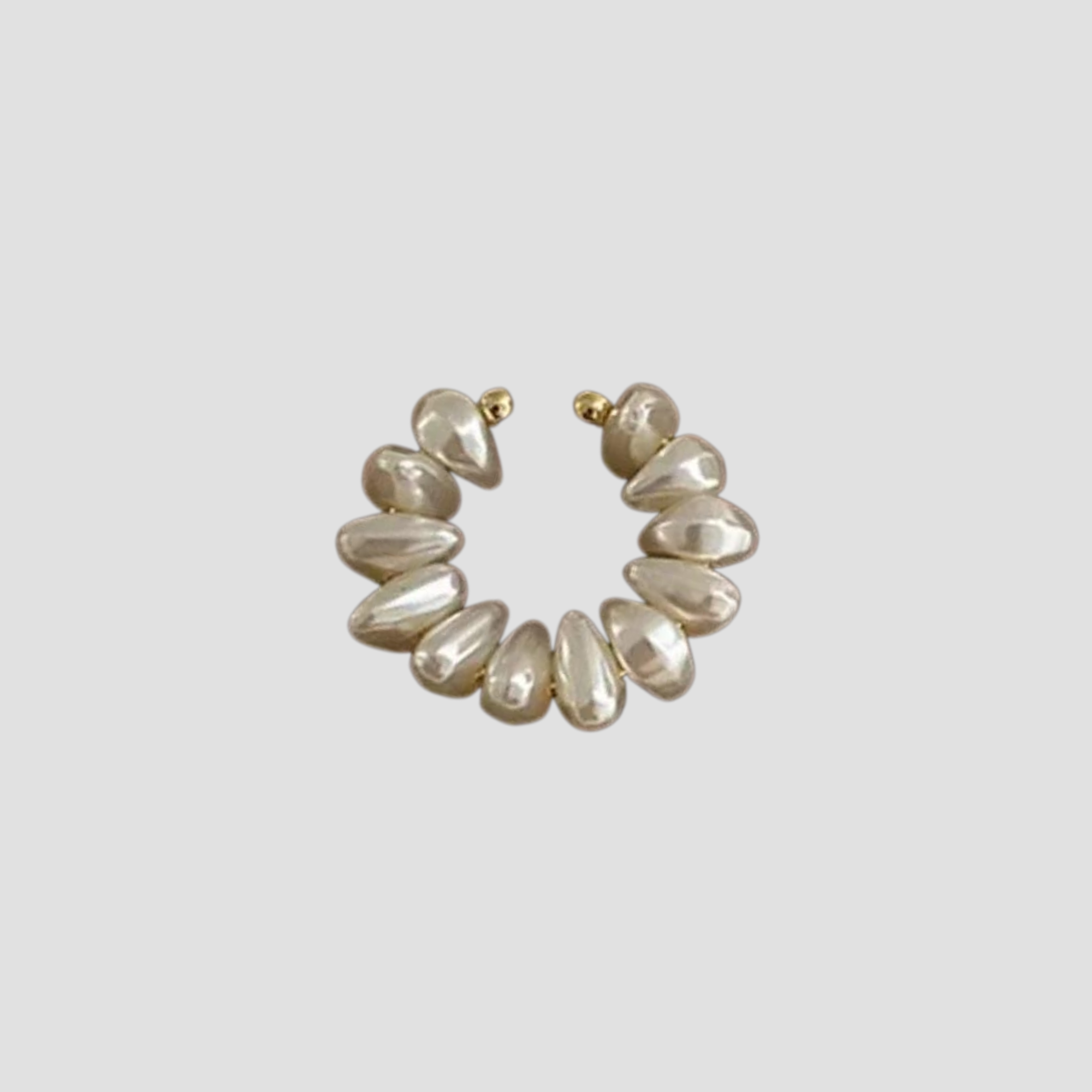 Freshwater pearl single ear cuff with gold tone setting by GRISÉ NYC.
