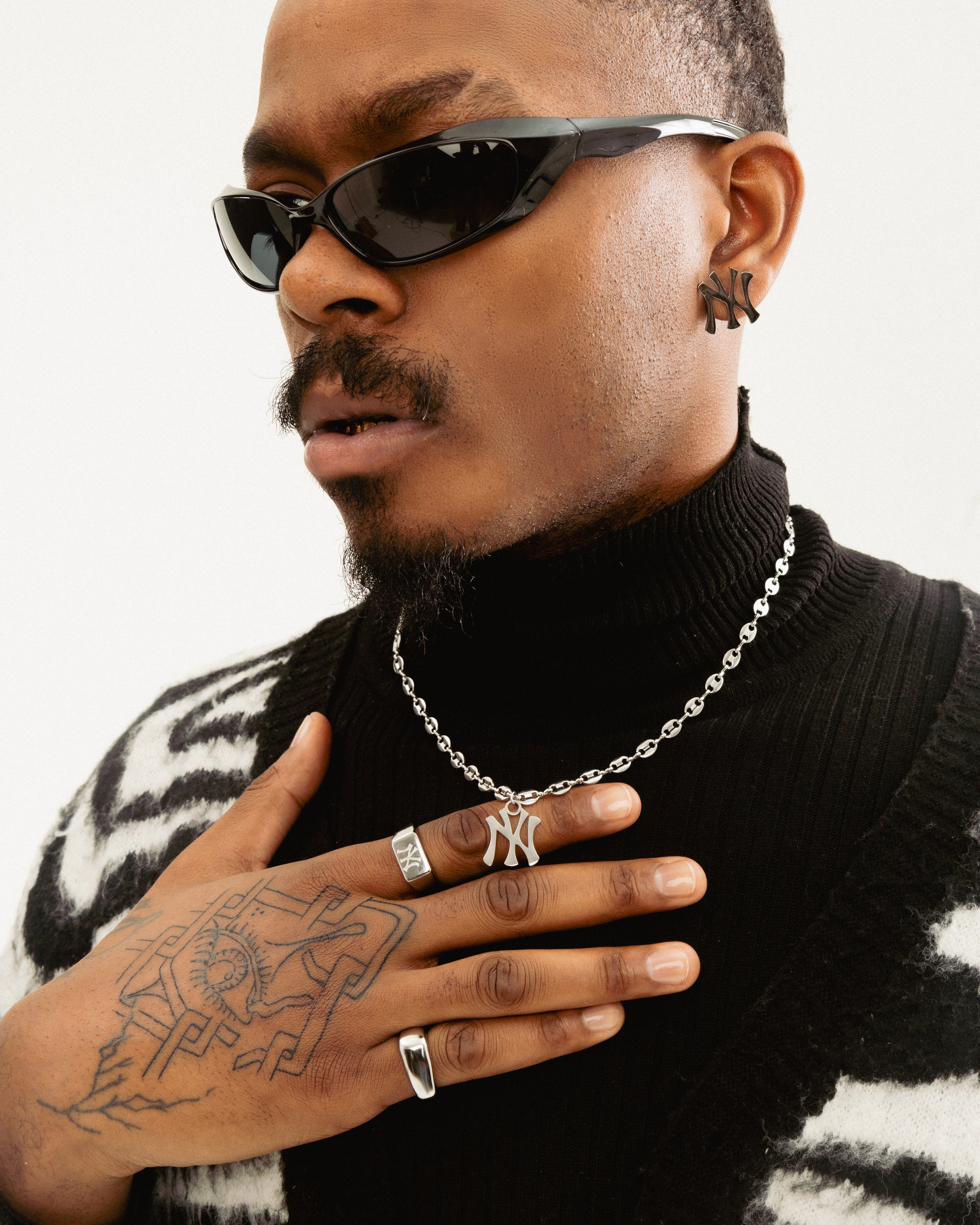 Male model wearing New York Yankees stainless steel mariner chain necklace in silver by GRISÉ NYC, bold statement pendant.