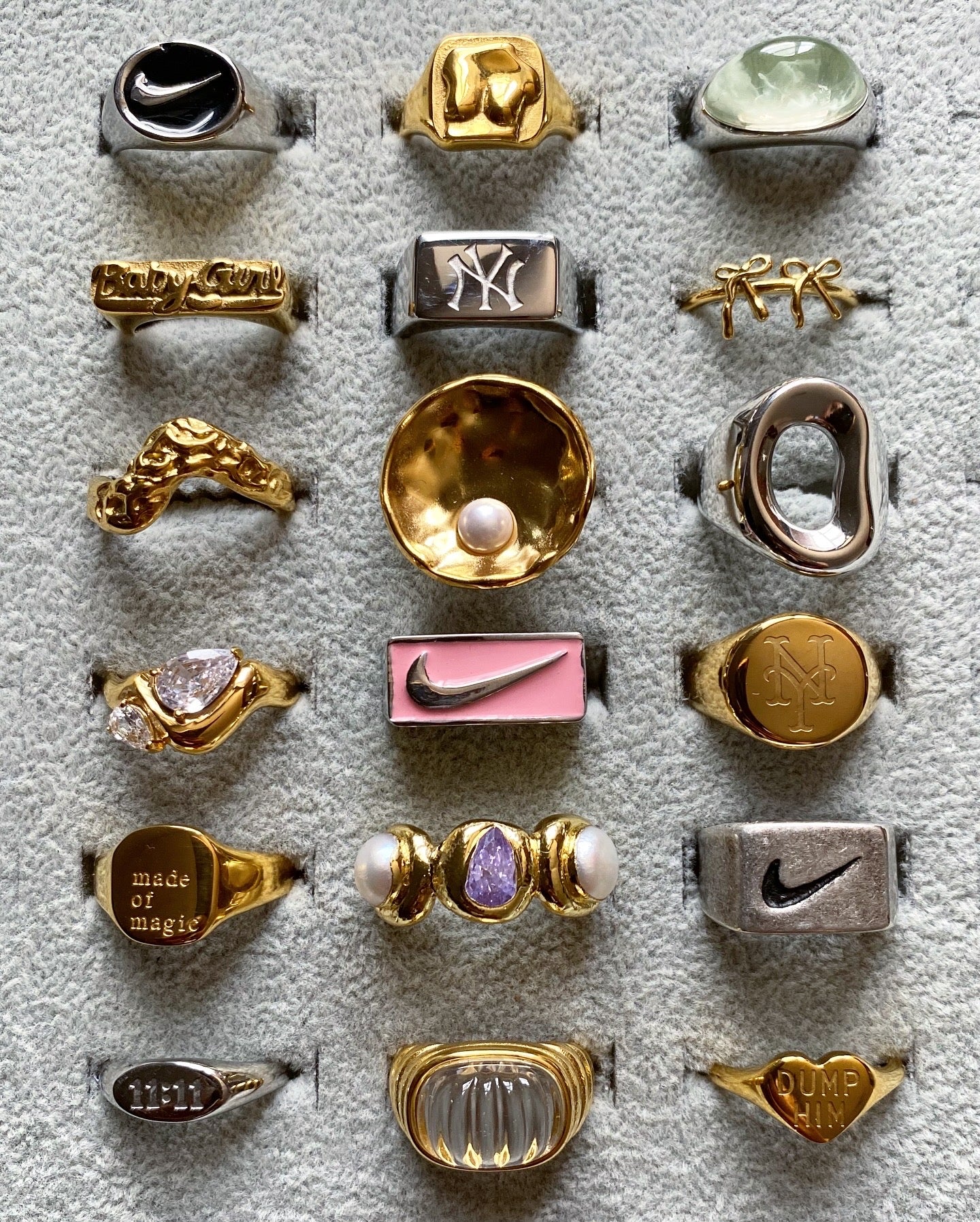 Display of GRISÉ NYC statement rings featuring gold and silver finishes, gemstone details, and sculptural modern designs.