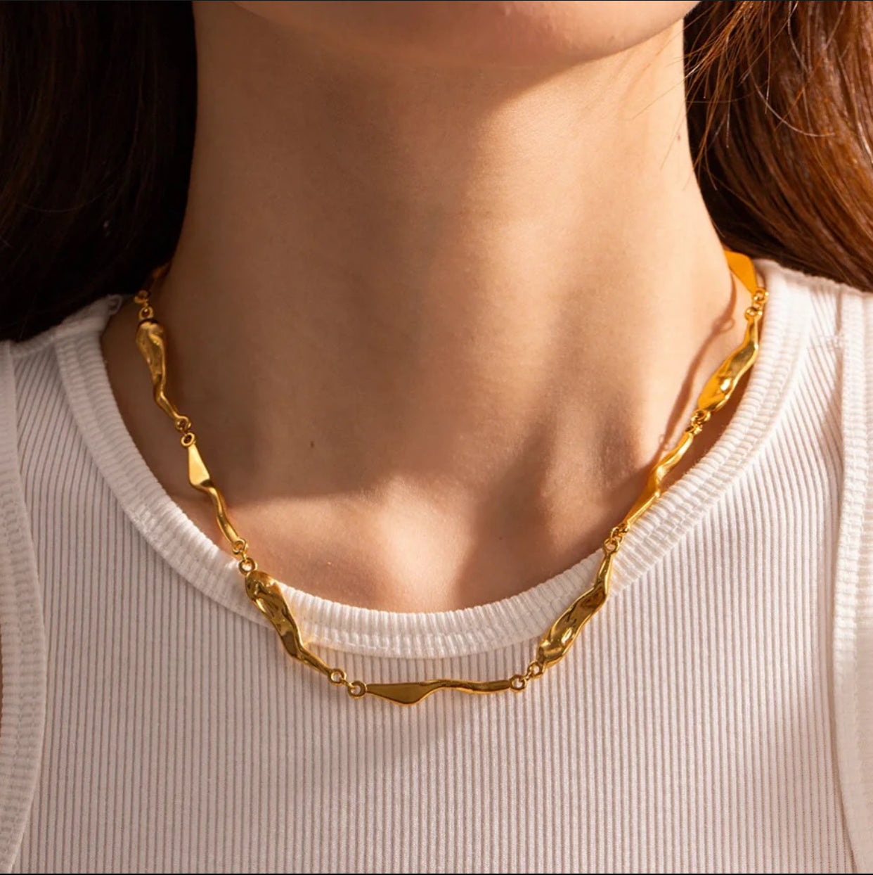 Model wearing GRISÉ NYC rugged textured gold necklace close up