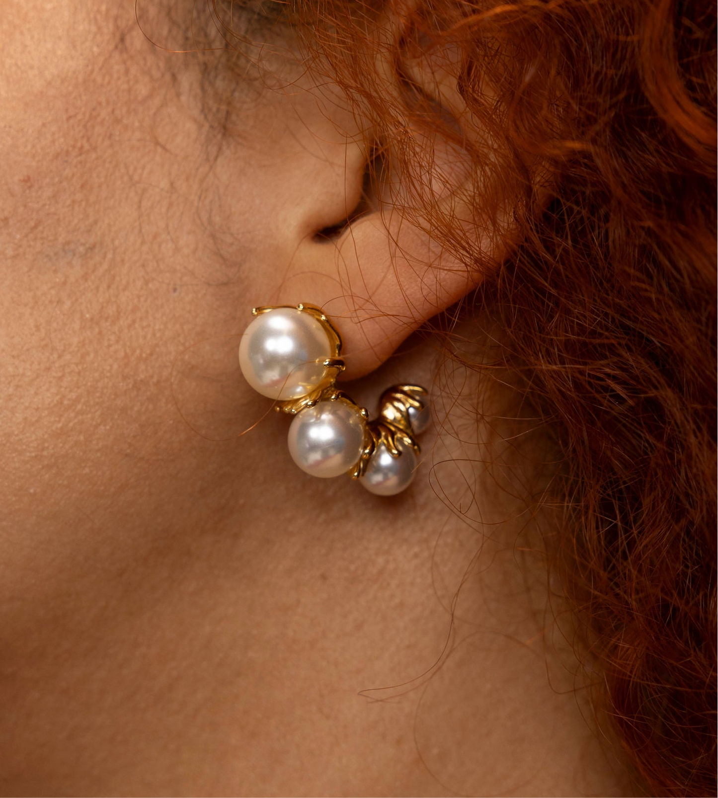 Tres Perlita 18k gold pearl earrings by GRISÉ NYC worn on ear showcasing triple pearl cluster and sculptural gold detailing,