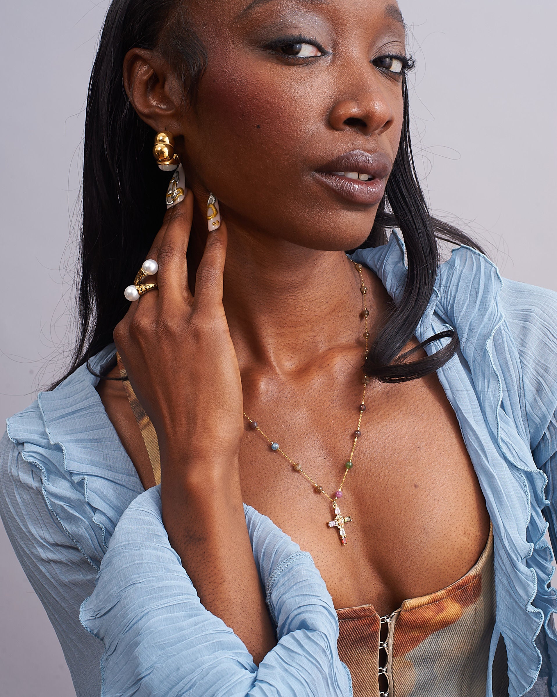 GRISÉ NYC pearl crossover ring styled with gold jewelry.