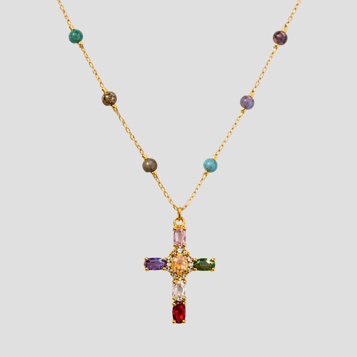Multicolor gemstone cross pendant beaded gold necklace by GRISÉ NYC featuring colorful stones and delicate gold chain.