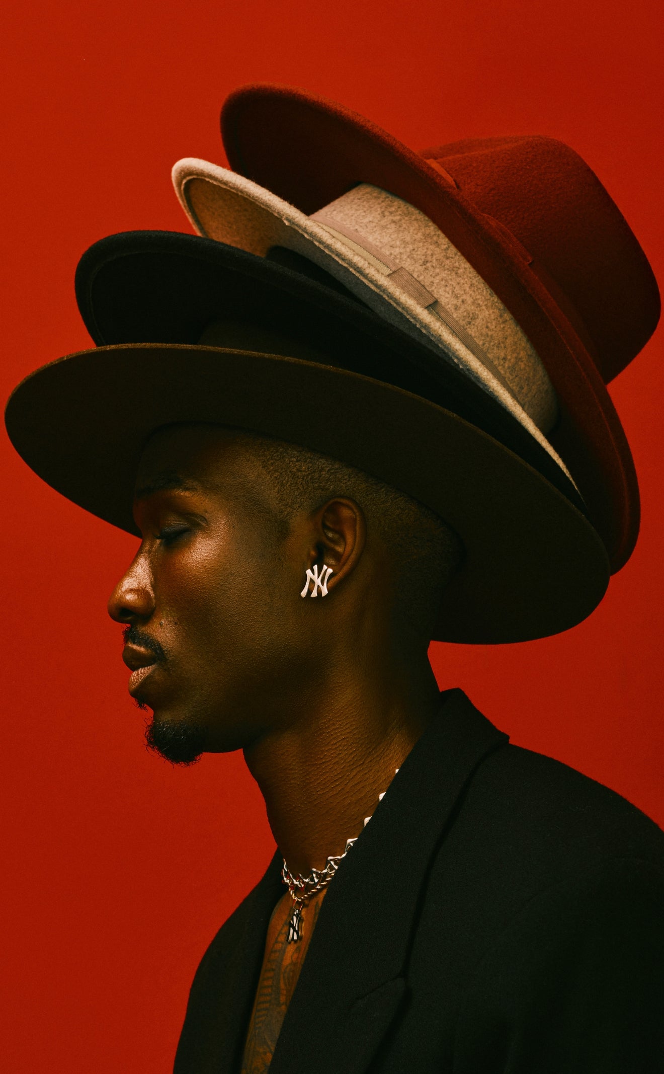 Side profile of model wearing GRISÉ NYC New York Yankees stainless steel stud earrings in silver.