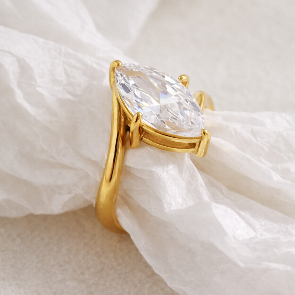 GRISÉ NYC Luna Marquise Ring 18k gold plated stainless steel cubic zirconia marquise ring on soft fabric background