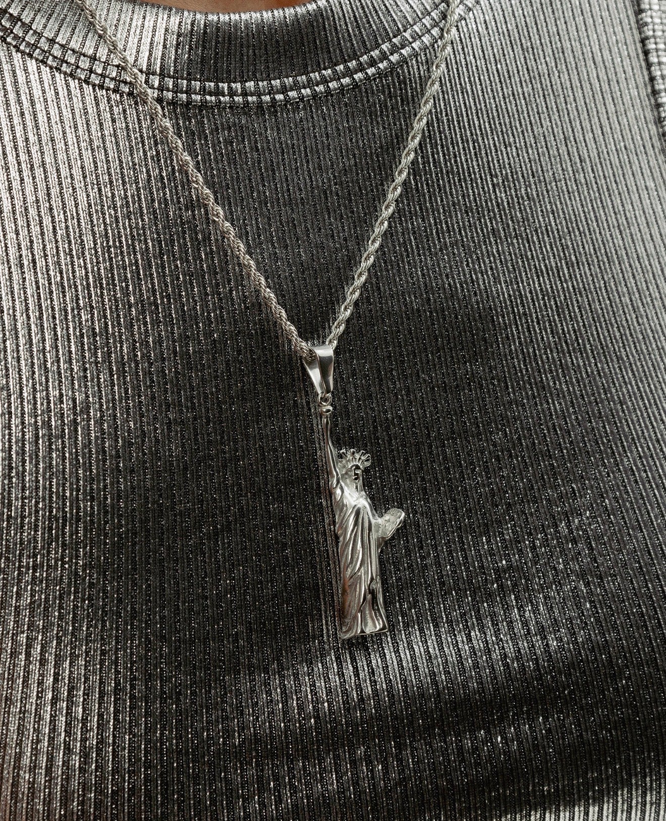 Close up Statue of Liberty silver pendant necklace styling photo by GRISÉ NYC