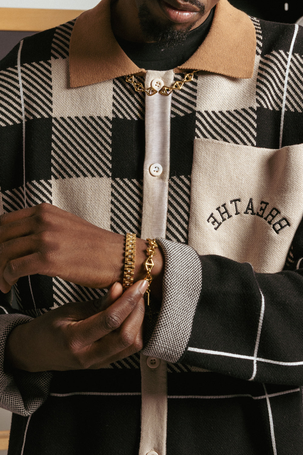 Male model wearing triangle mariner gold stainless steel necklace by GRISÉ NYC.