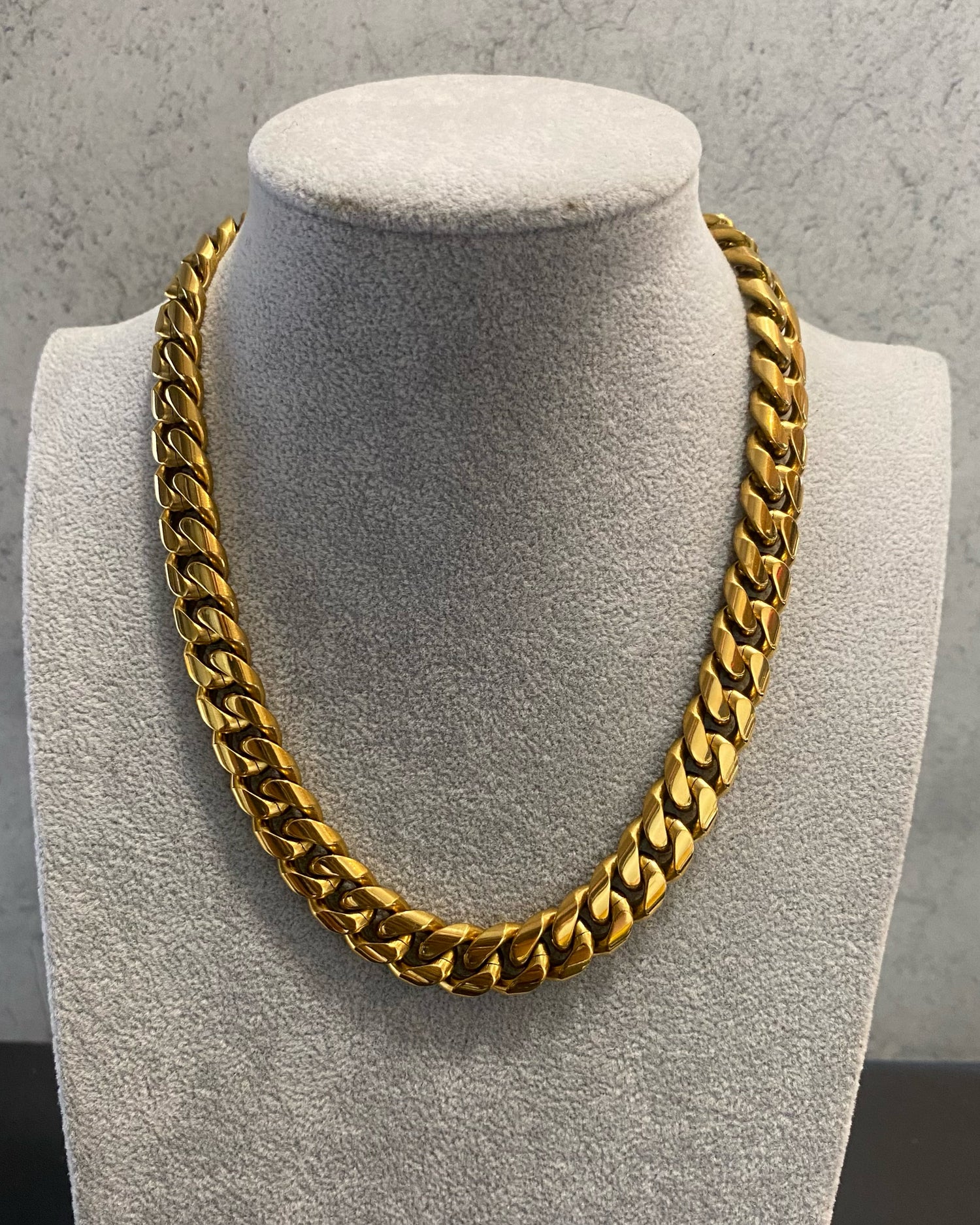 18k gold thick cuban link necklace on jewelry display by GRISÉ NYC