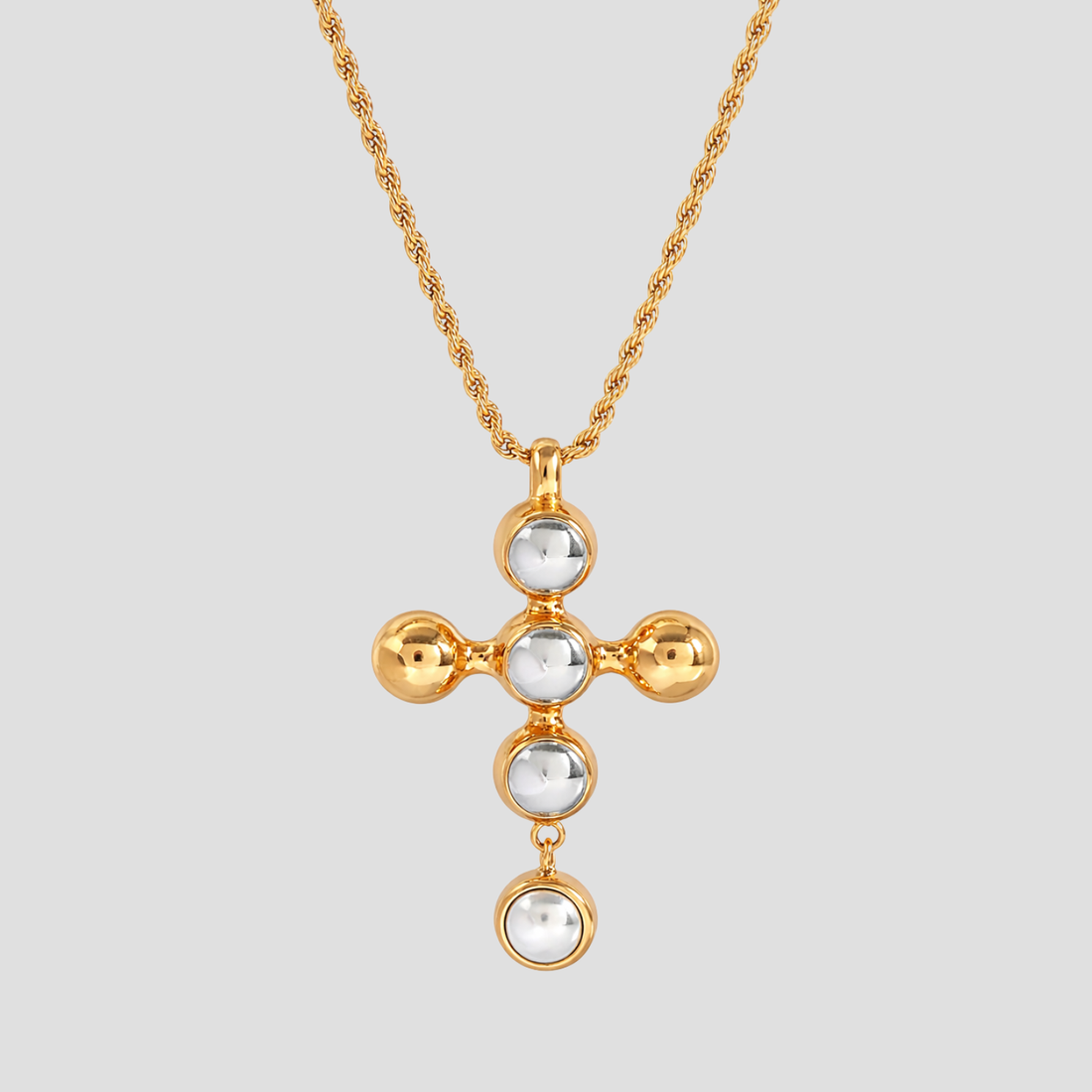 Radiant 2-Tone Harmony Cross Pendant Necklace in 18k gold plated stainless steel with polished steel cabochons and pearl drop detail by GRISÉ NYC.