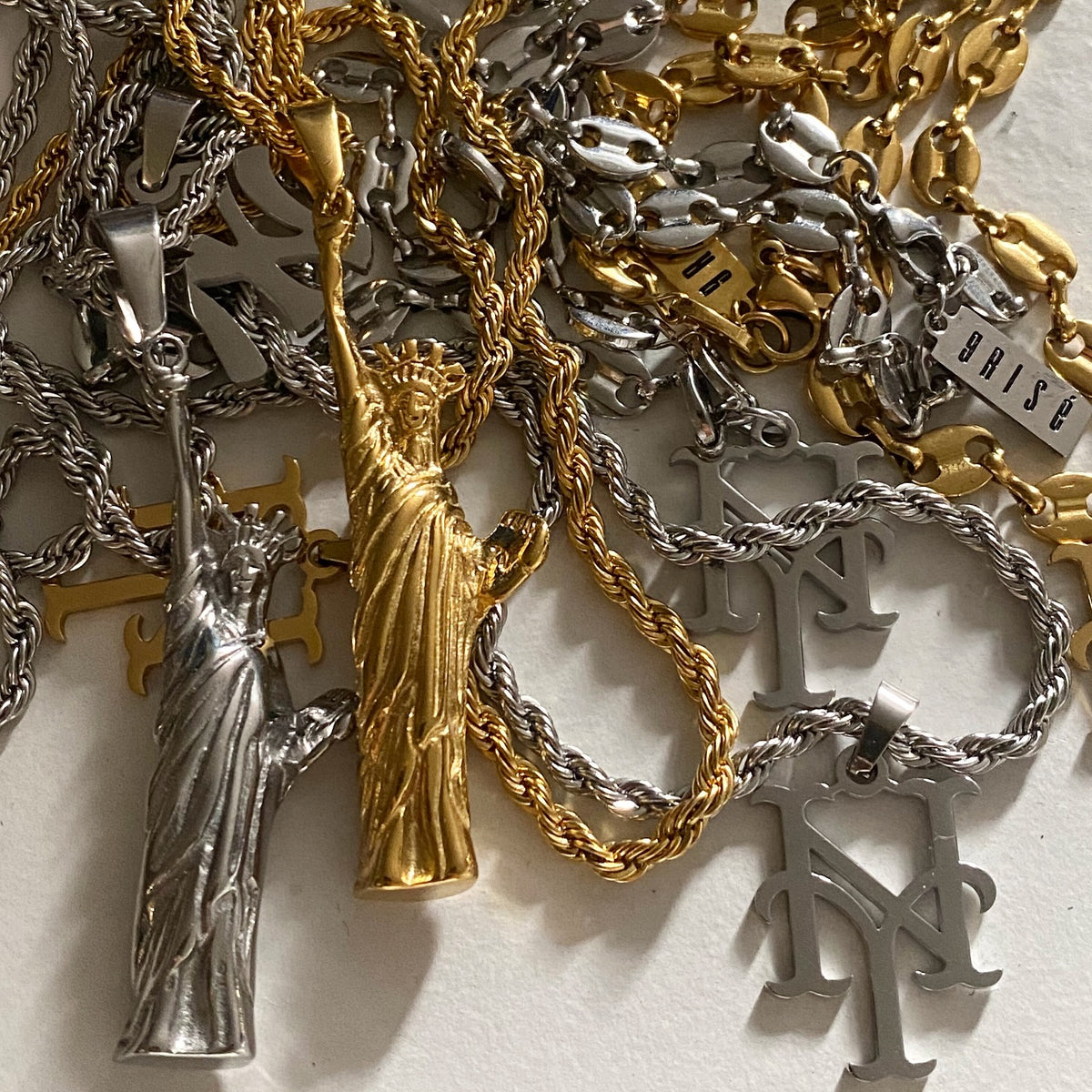 GRISÉ NYC Statue of Liberty pendant necklaces in 18k gold plated and stainless steel