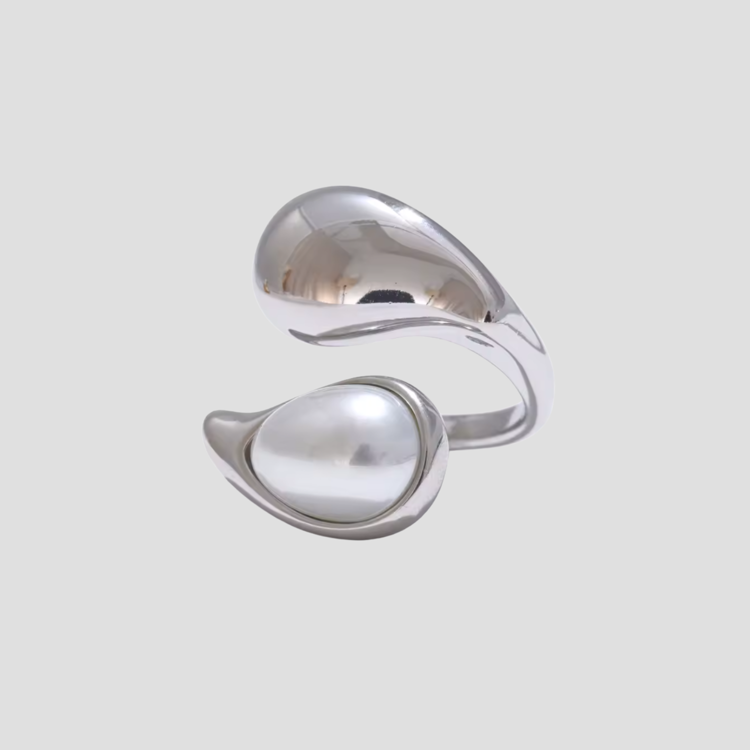 Silver ring with a large pearl on a light gray background