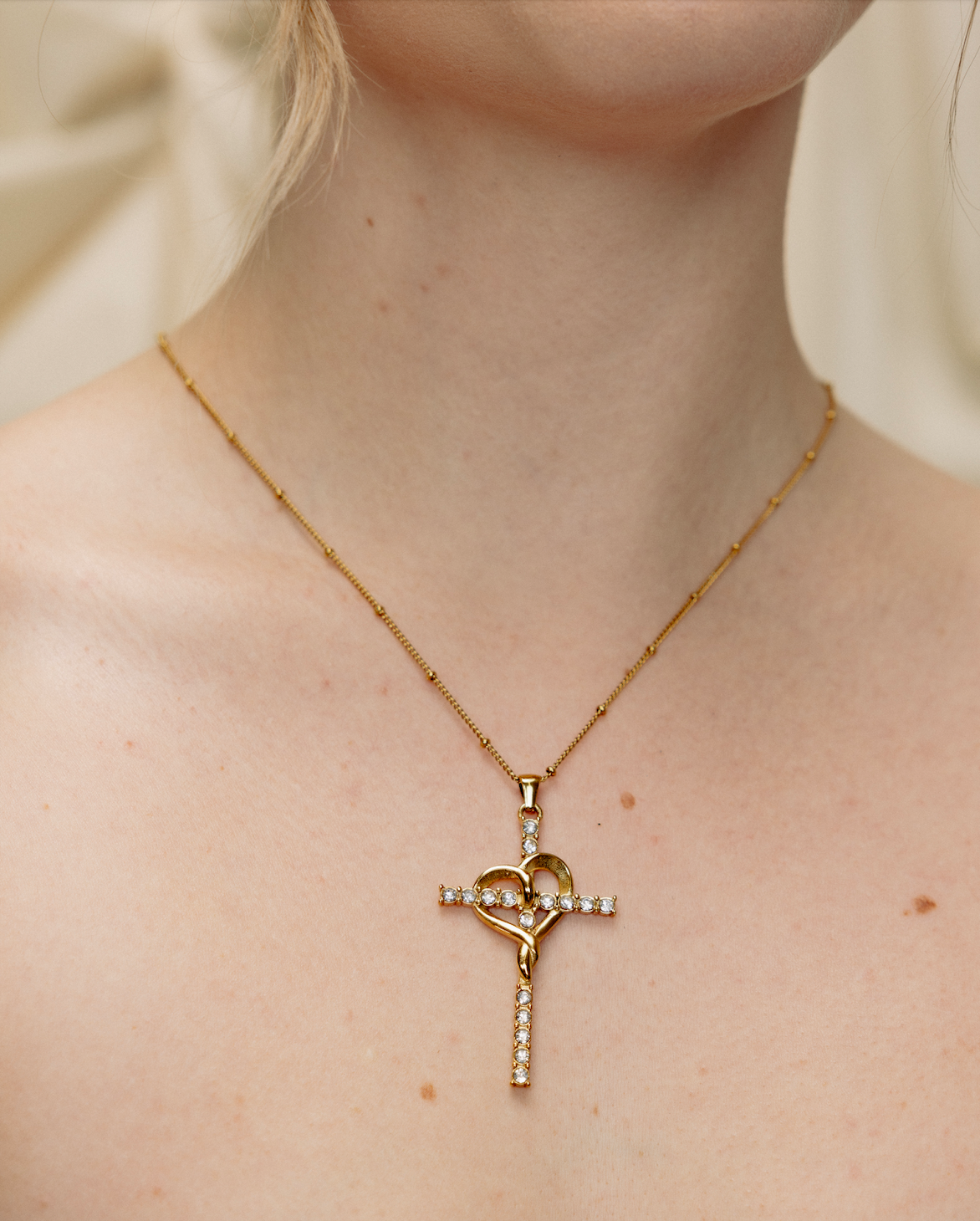 gold amour cross necklace worn on model layering necklace cubic zirconia