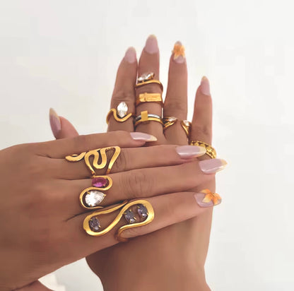 Stacked styling of GRISÉ NYC statement rings with the Aurelia Amethyst Gemstone 18k Gold Ring as the centerpiece.