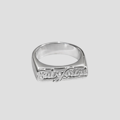 Babygirl Stainless Steel Ring by GRISÉ NYC featuring raised script lettering in polished stainless steel on a light grey background