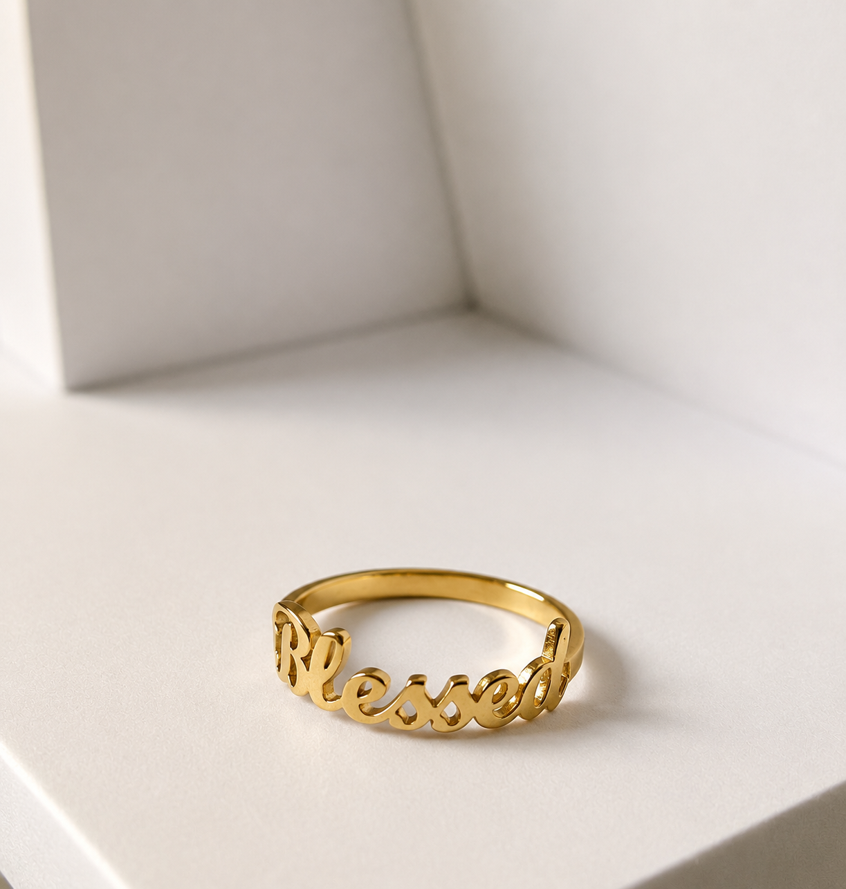 Blessed Ring in 18k gold plated stainless steel displayed on a minimalist white surface by GRISÉ NYC.