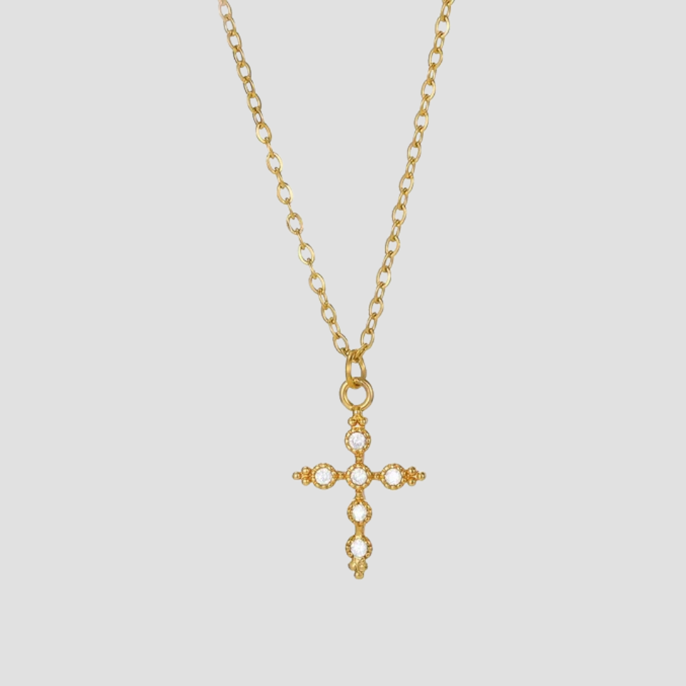 Dainty 18K gold cross pendant necklace crafted from gold-plated stainless steel with a minimalist cross charm on a fine chain by GRISÉ NYC.