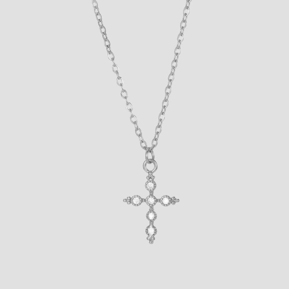 Dainty silver cross pendant necklace crafted from stainless steel featuring a minimalist cross charm on a fine chain by GRISÉ NYC.