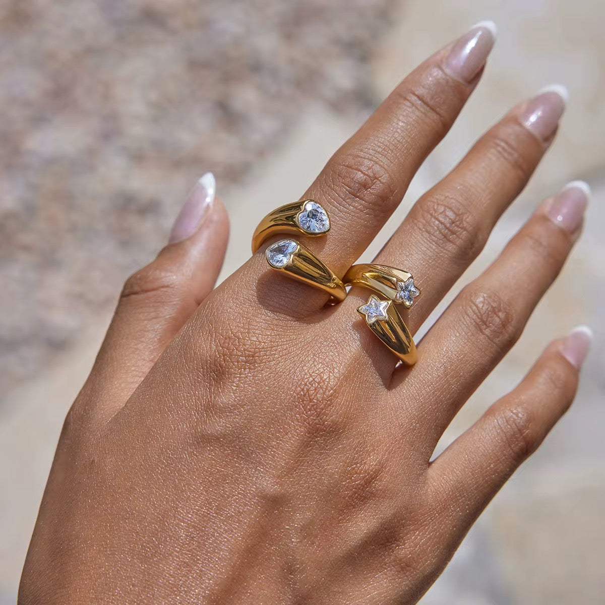 Lifestyle view of Double Star Gemstone adjustable ring in 18k gold plated stainless steel worn on hand by GRISÉ NYC.