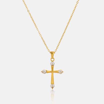 Close-up detail of the Eterna 18K gold cross pendant necklace featuring polished gold plating and brilliant cubic zirconia by GRISÉ NYC.