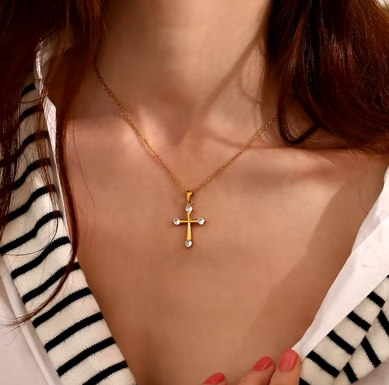 Model wearing the Eterna 18K gold cross pendant necklace with brilliant cubic zirconia on a delicate gold chain by GRISÉ NYC.