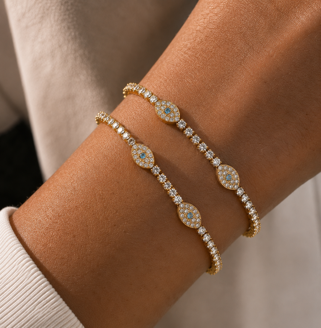 GRISÉ NYC Evil Eye Tennis Bracelet layered with gold jewelry for an everyday stacked look.