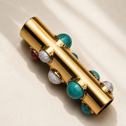 Luxury gold BIC J6 lighter case with turquoise gemstone detailing by GRISÉ NYC photographed on a soft neutral surface.