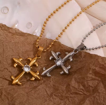 Detailed view of Lumière cross pendants with cubic zirconia center