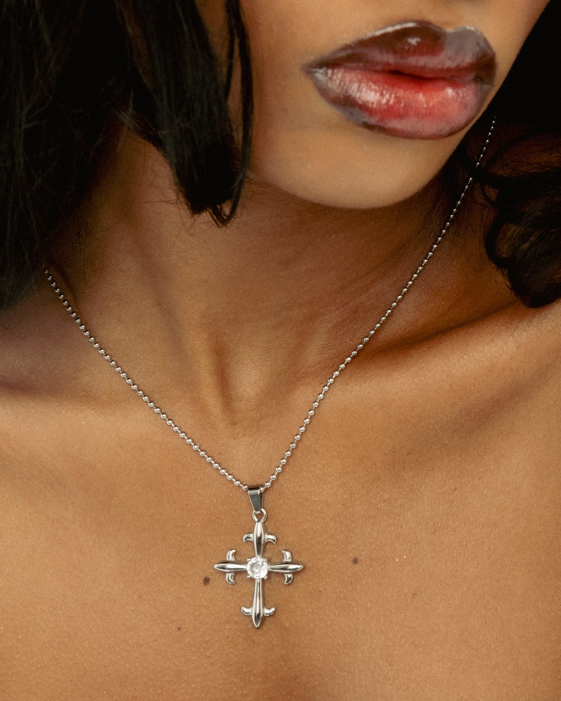 Silver statement cross pendant necklace styled on model