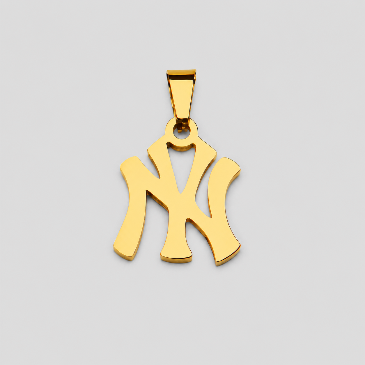 Polished gold NY pendant necklace charm on light grey background, minimalist Yankees inspired monogram jewelry