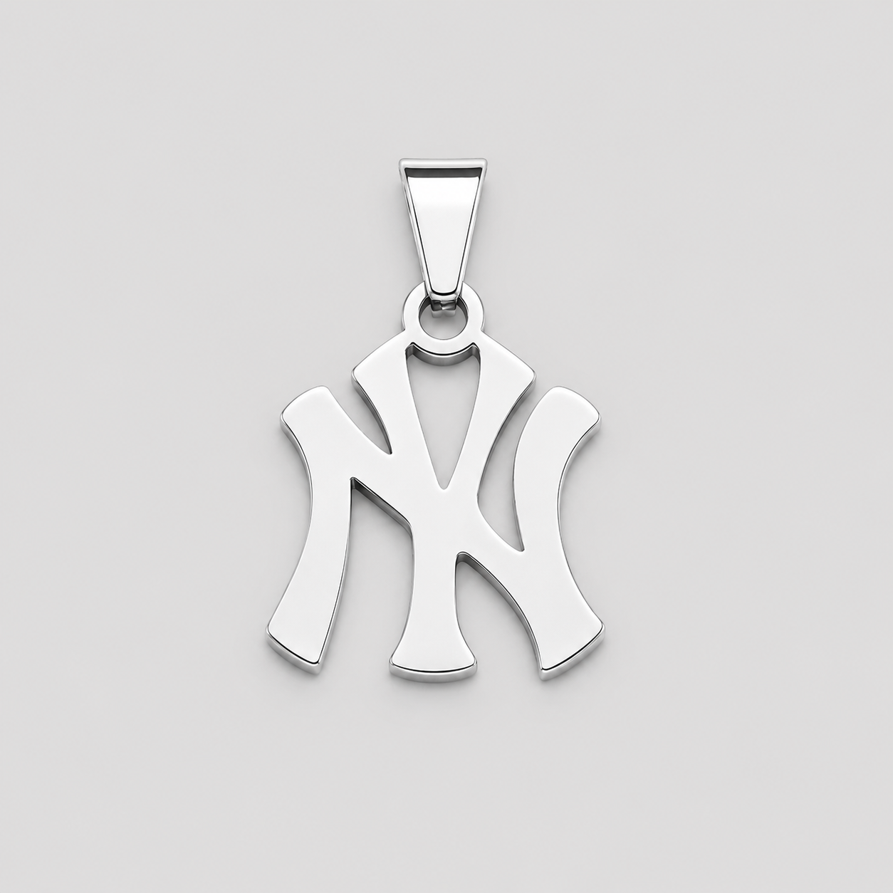 Polished silver NY pendant necklace charm on light grey background, minimalist Yankees inspired monogram jewelry
