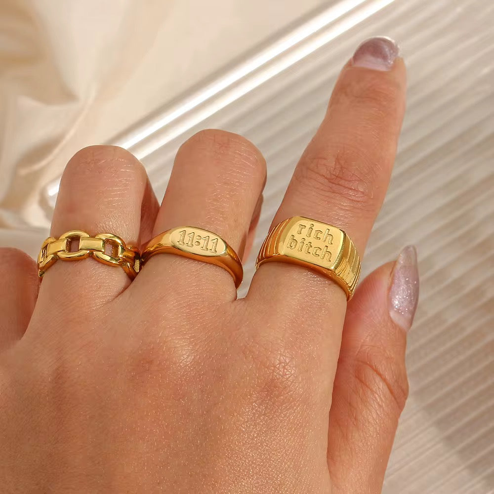 GRISÉ NYC 18k gold 11:11 signet ring styled with gold rings