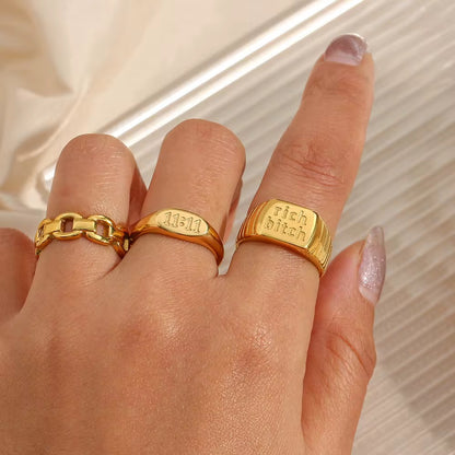 GRISÉ NYC 18k gold 11:11 signet ring styled with gold rings