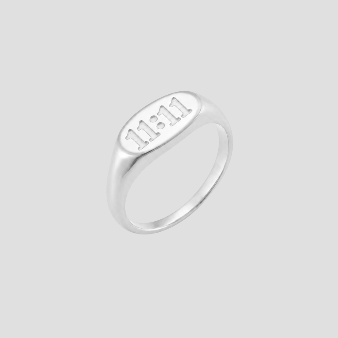 GRISÉ NYC silver 11:11 signet ring on a light grey background