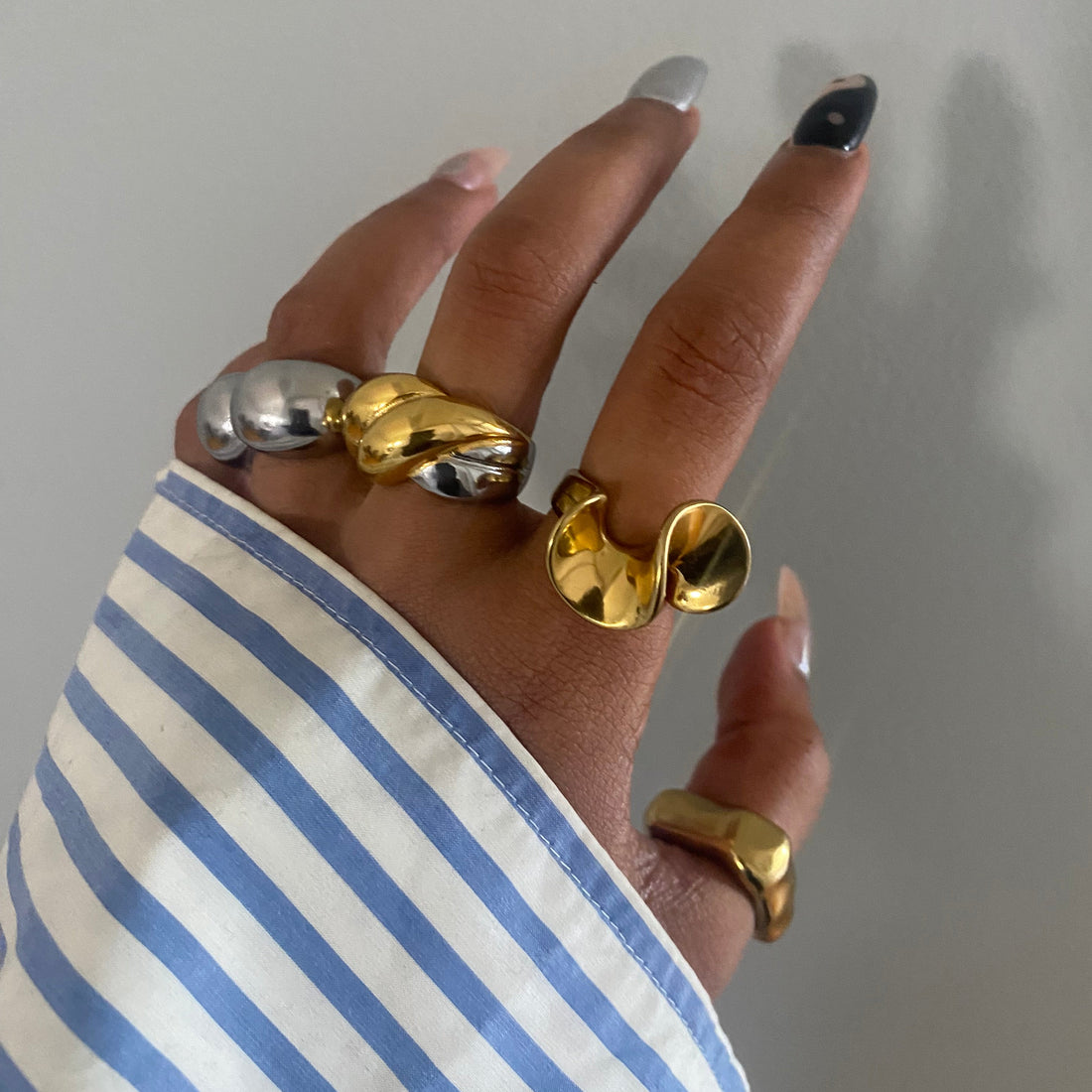 GRISÉ NYC 2-Tone XL Bubble Ring styled on hand with mixed metal jewelry and blue striped sleeve