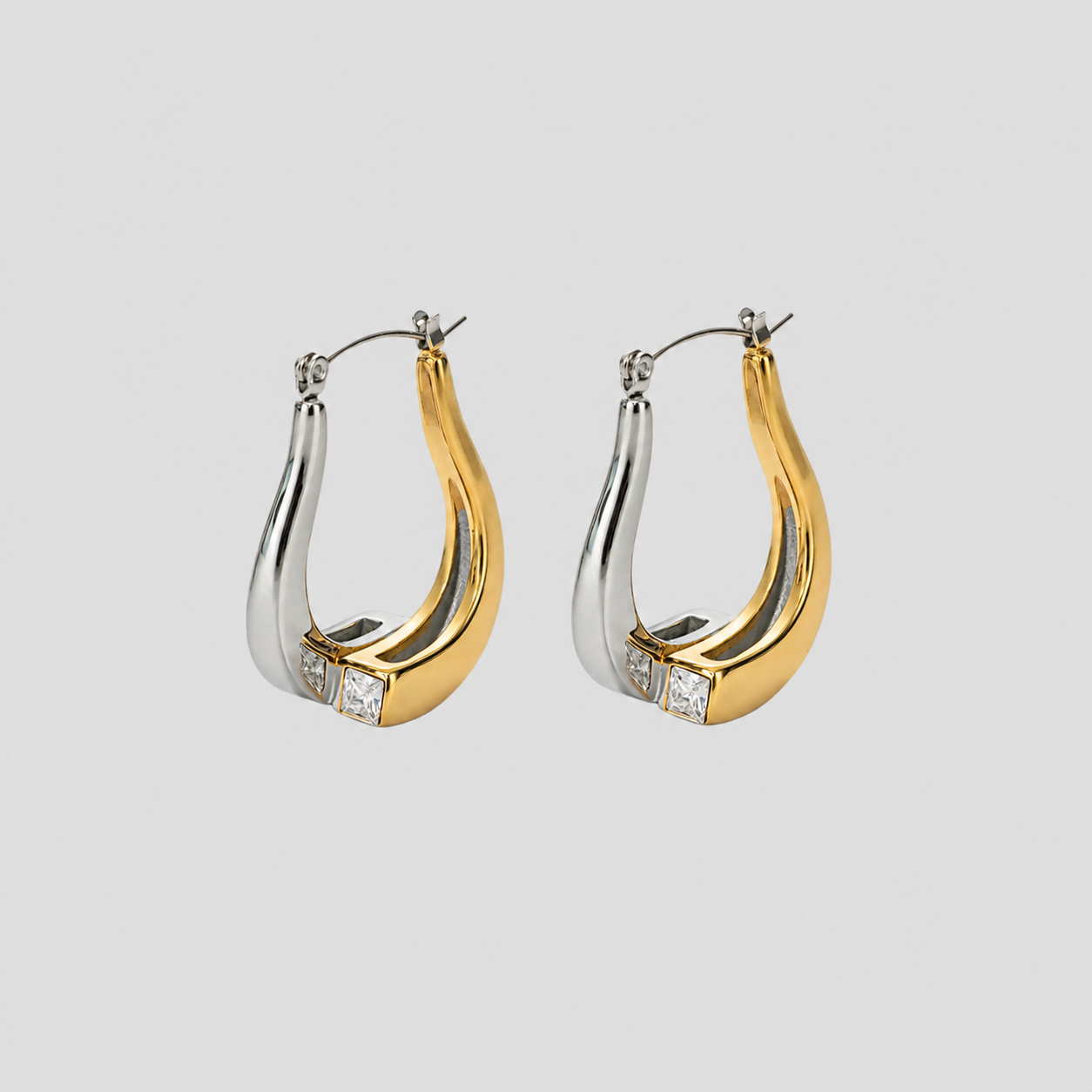 Flat lay of GRISÉ NYC 2-tone gemstone teardrop earrings.