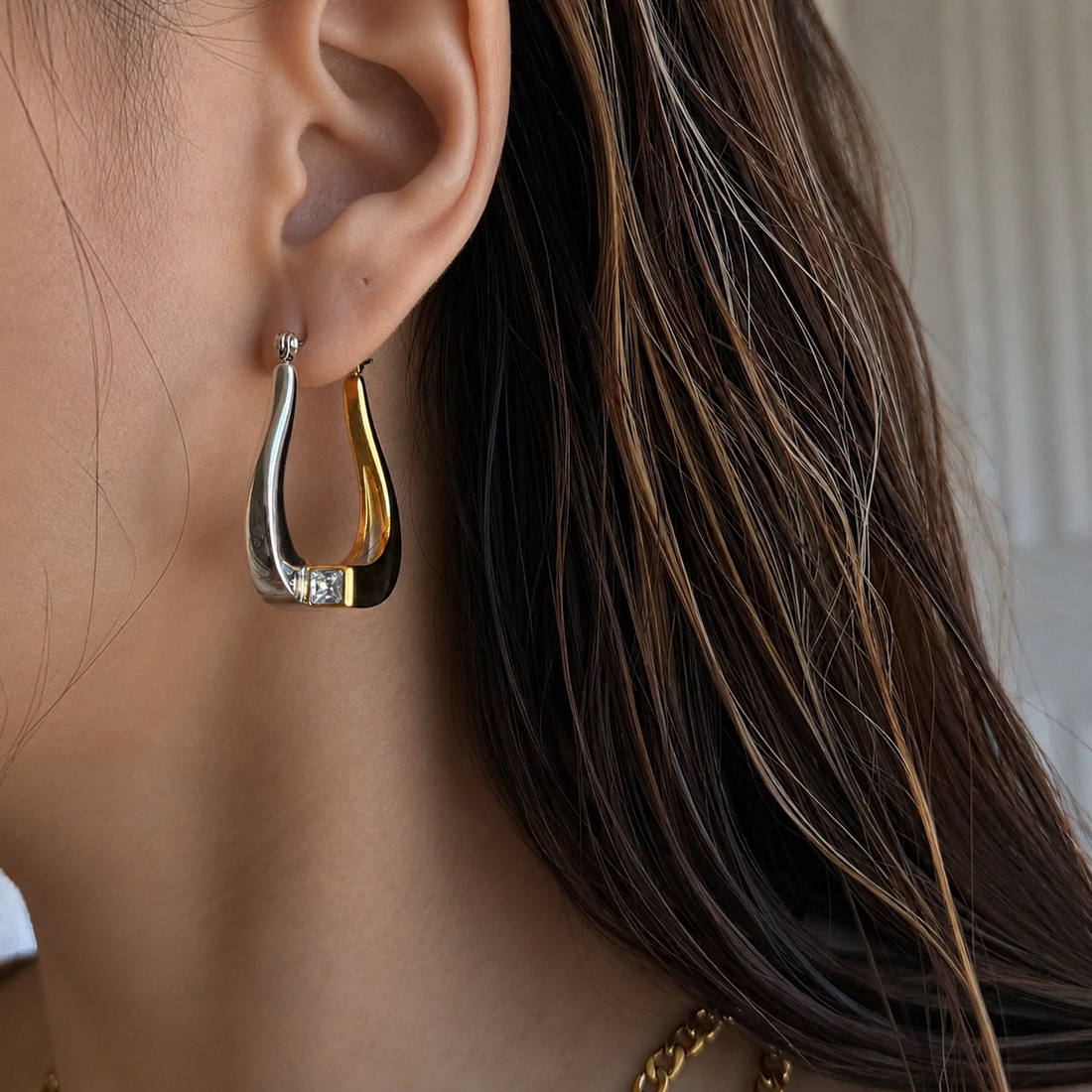 Model wearing GRISÉ NYC gold plated teardrop earrings.