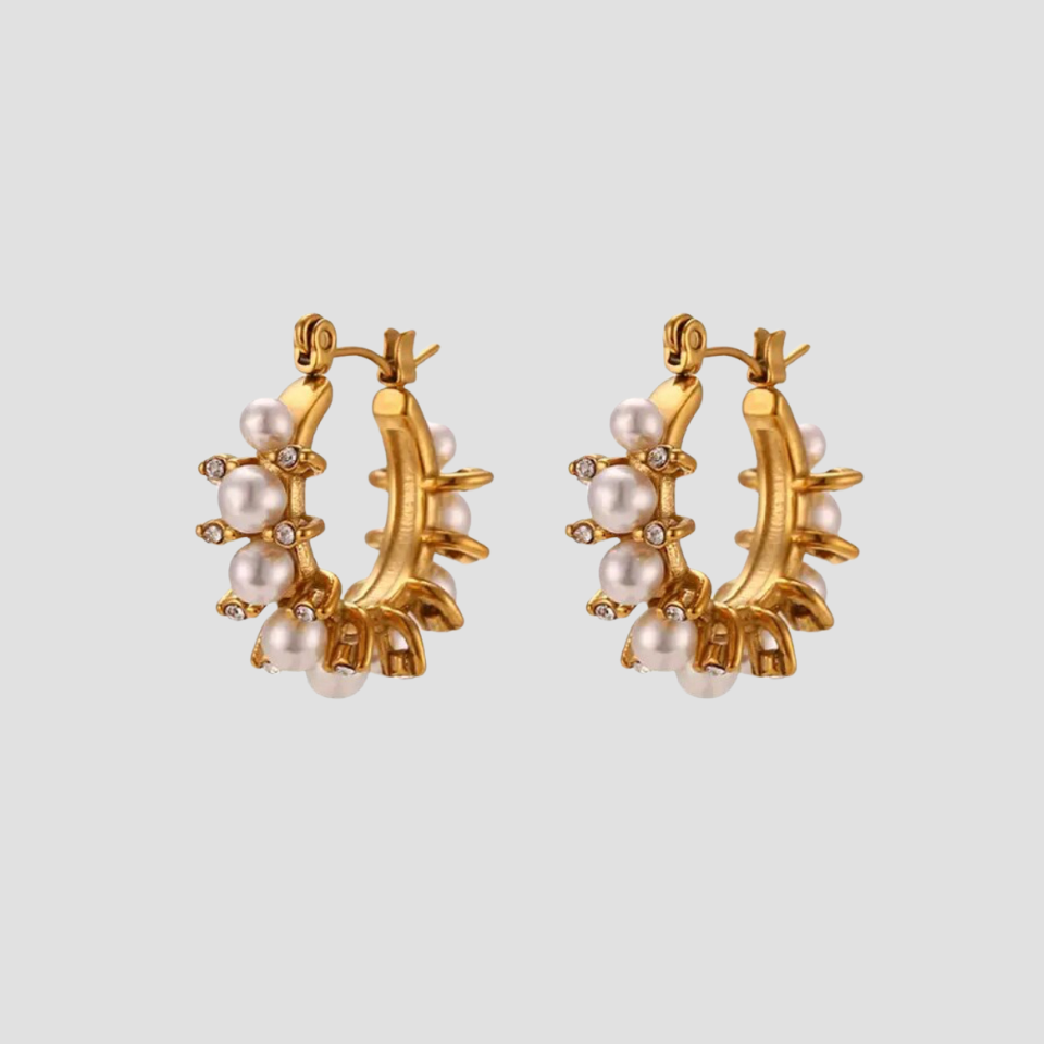 Adorned pearl hoop earrings in 18k gold plated stainless steel with simulated pearls and cubic zirconia accents by GRISÉ NYC.