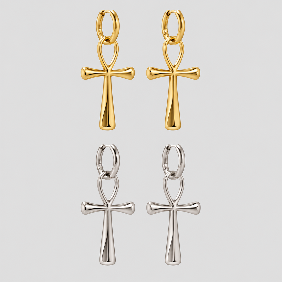 Alt Text: GRISÉ NYC Ankh Statement Drop Earrings in gold and silver featuring polished stainless steel ankh cross pendants suspended from hinged hoop earrings.