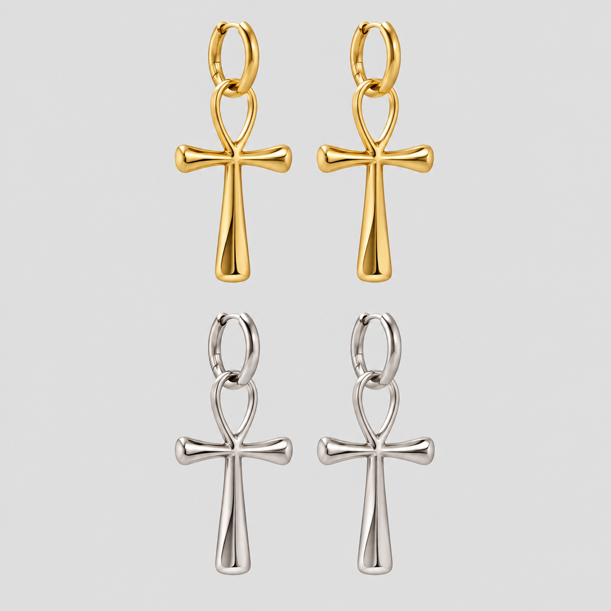 Alt Text: GRISÉ NYC Ankh Statement Drop Earrings in gold and silver featuring polished stainless steel ankh cross pendants suspended from hinged hoop earrings.