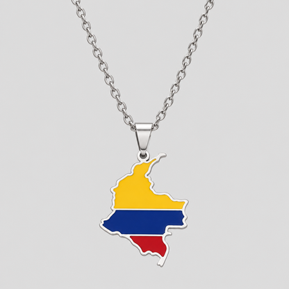 Silver Colombia flag map pendant necklace by GRISÉ NYC featuring yellow, blue, and red enamel detailing, polished silver-tone edges, and a silver cable chain on a light gray background.