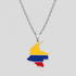 Silver Colombia flag map pendant necklace by GRISÉ NYC featuring yellow, blue, and red enamel detailing, polished silver-tone edges, and a silver cable chain on a light gray background.