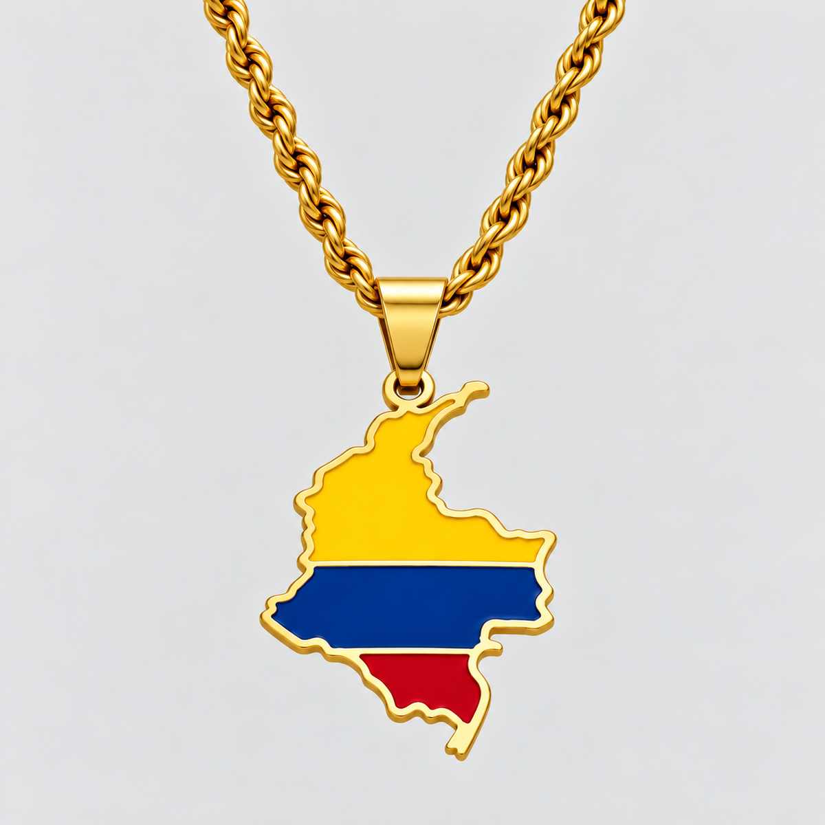 GRISÉ NYC gold Colombia flag map pendant necklace featuring yellow, blue, and red enamel detailing, paired with a 3mm silver rope chain on a light grey background.