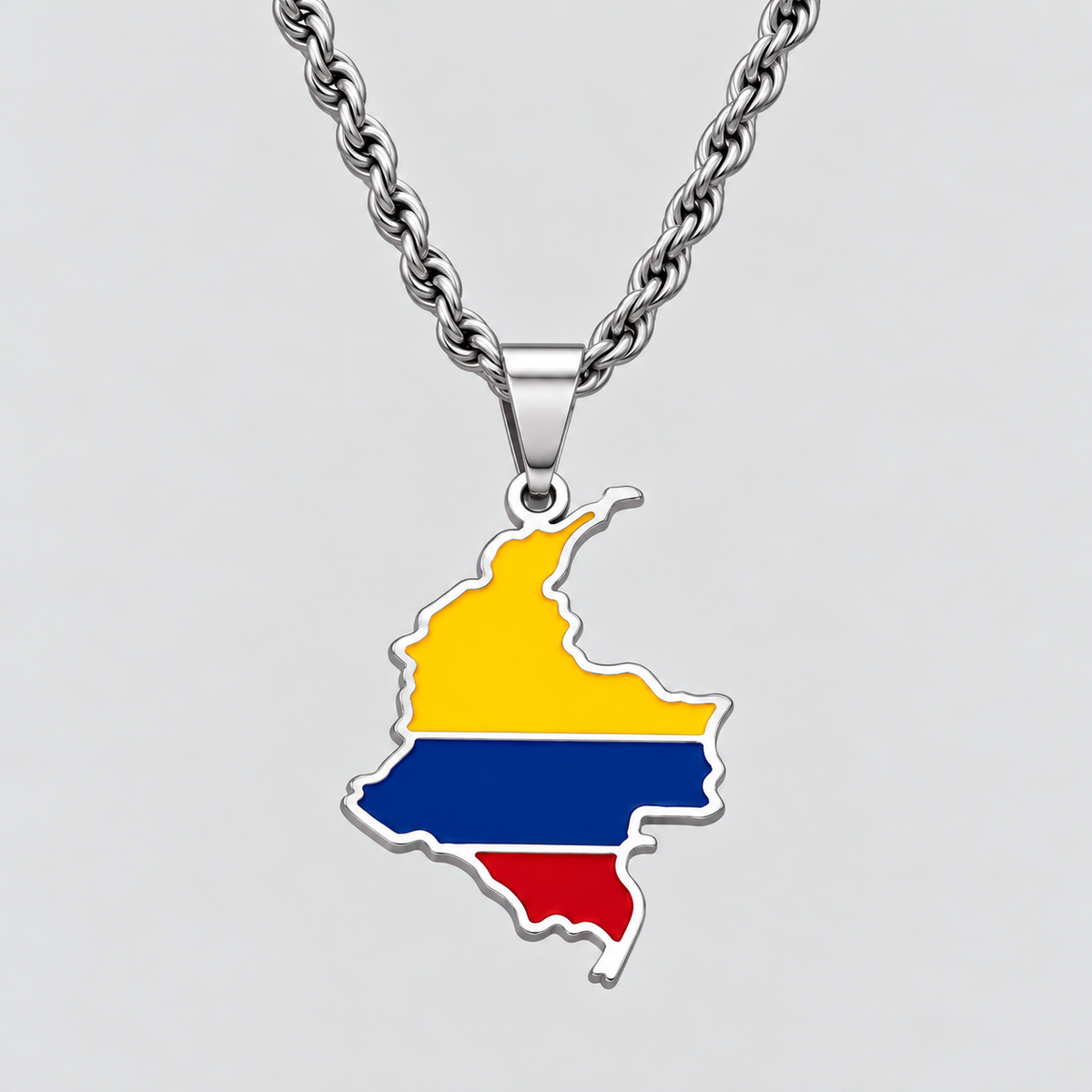 GRISÉ NYC silver Colombia flag map pendant necklace featuring yellow, blue, and red enamel detailing, paired with a 3mm silver rope chain on a light grey background.